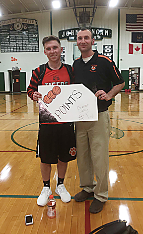 Couresty Photo Hillman's Gunnar Libby celebrates with coach Eric Muszynski after scoring his 1,000th career point in a victory over Cedarville on Tuesday. Libby poured in a game high 30 points in the win. 